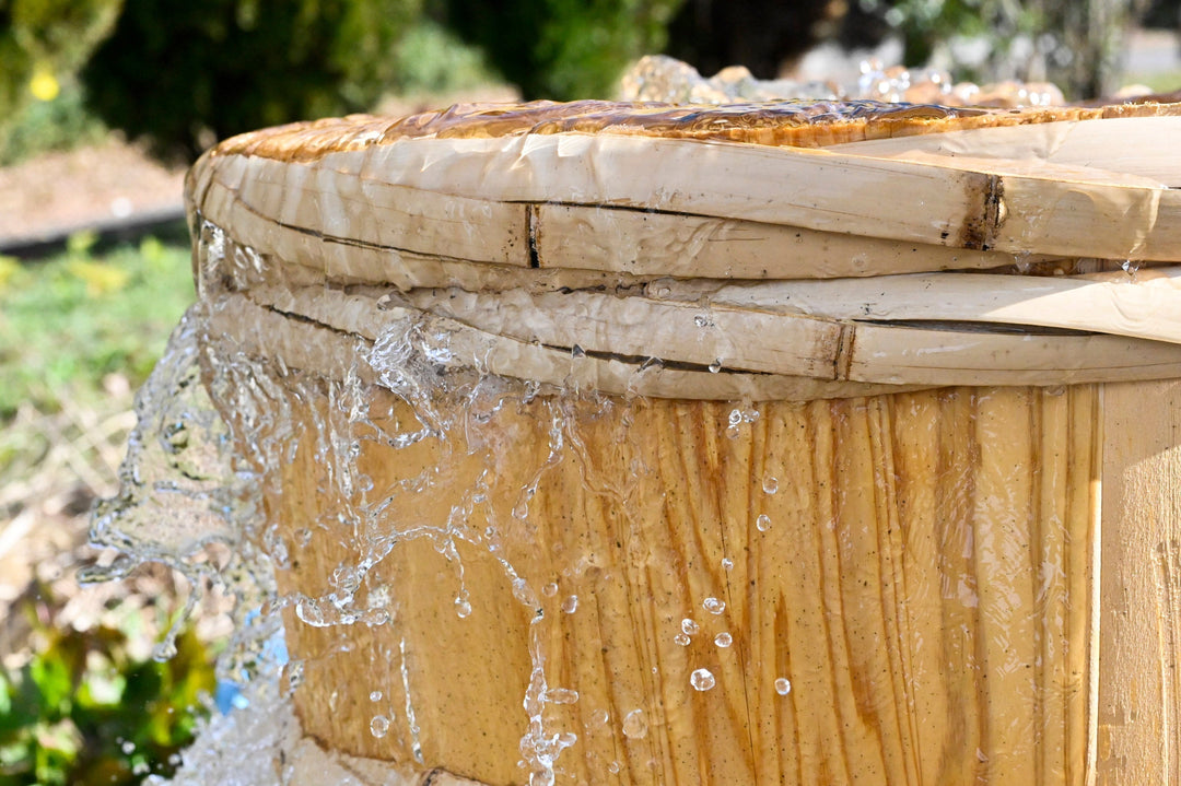 A traditional Japanese barrel overflowing with spring water - Photo credit: Sennari