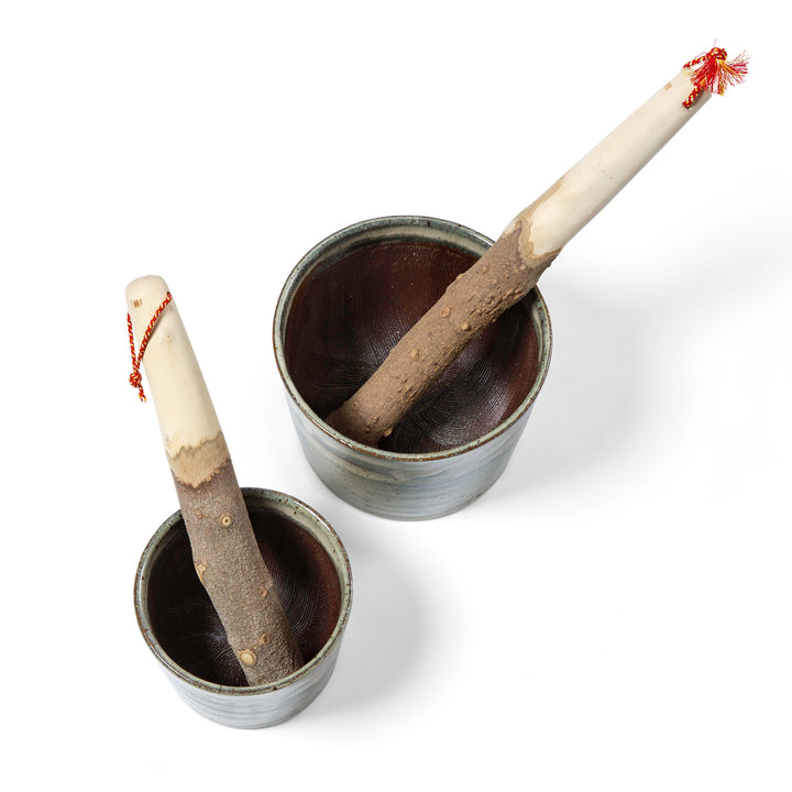 Small and medium sizes of Jizai Dougu Suribachi (Japanese mortar and pestle) with wooden handles and lids, one larger than the other, isolated on a white background.