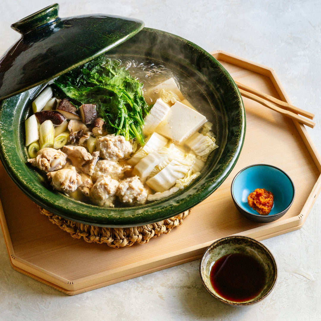 Mizutaki Japanese chicken hot pot in a donabe clay pot with chopsticks