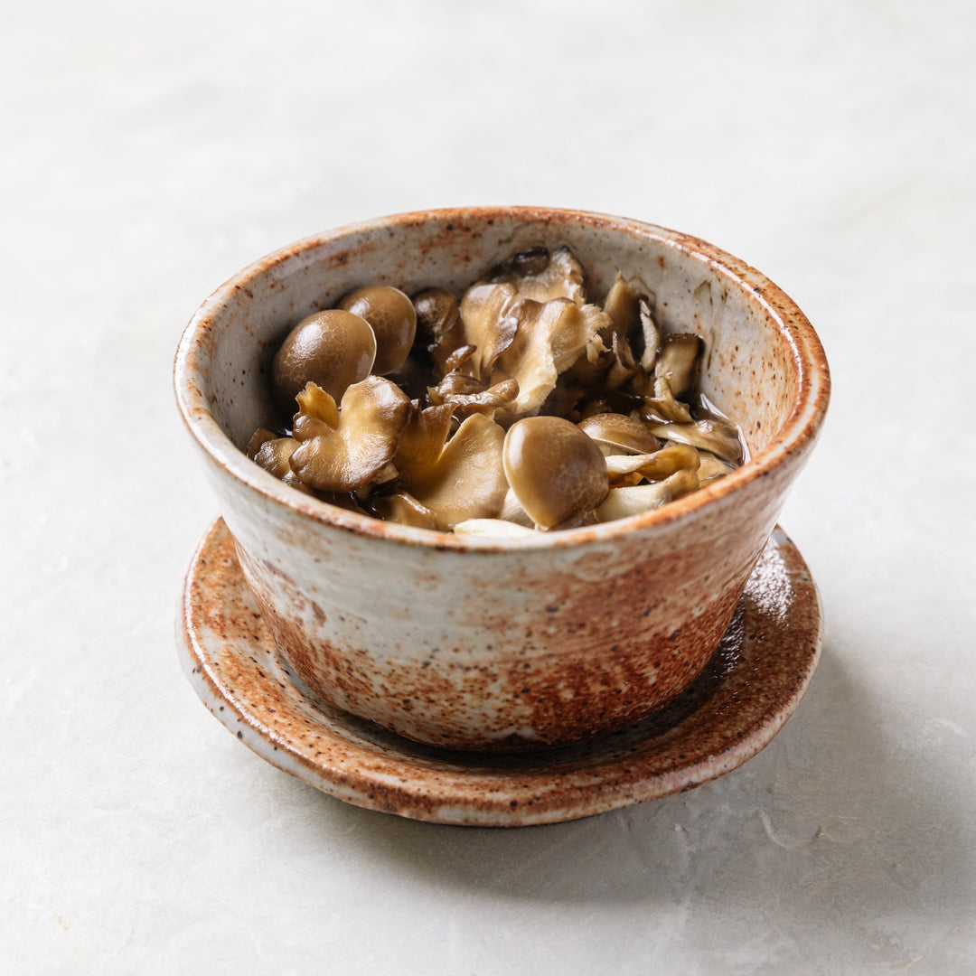 Ceramic bowl of steamed mushroom broth.