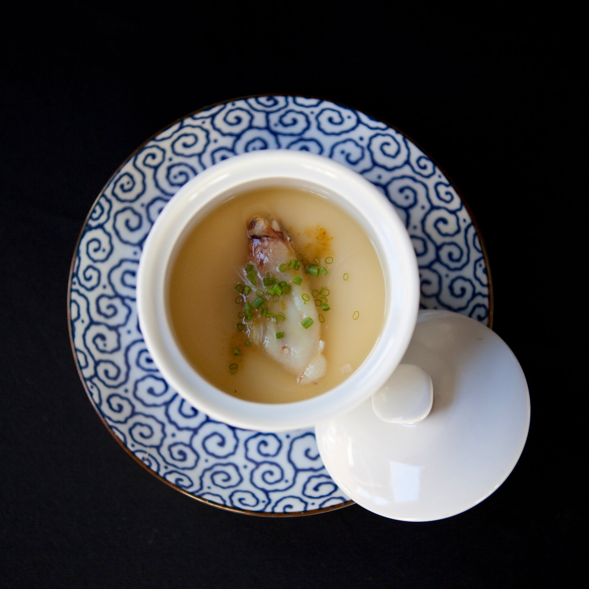 Chawan mushi — Japanese steamed egg custard with dashi and white tamari on a black background