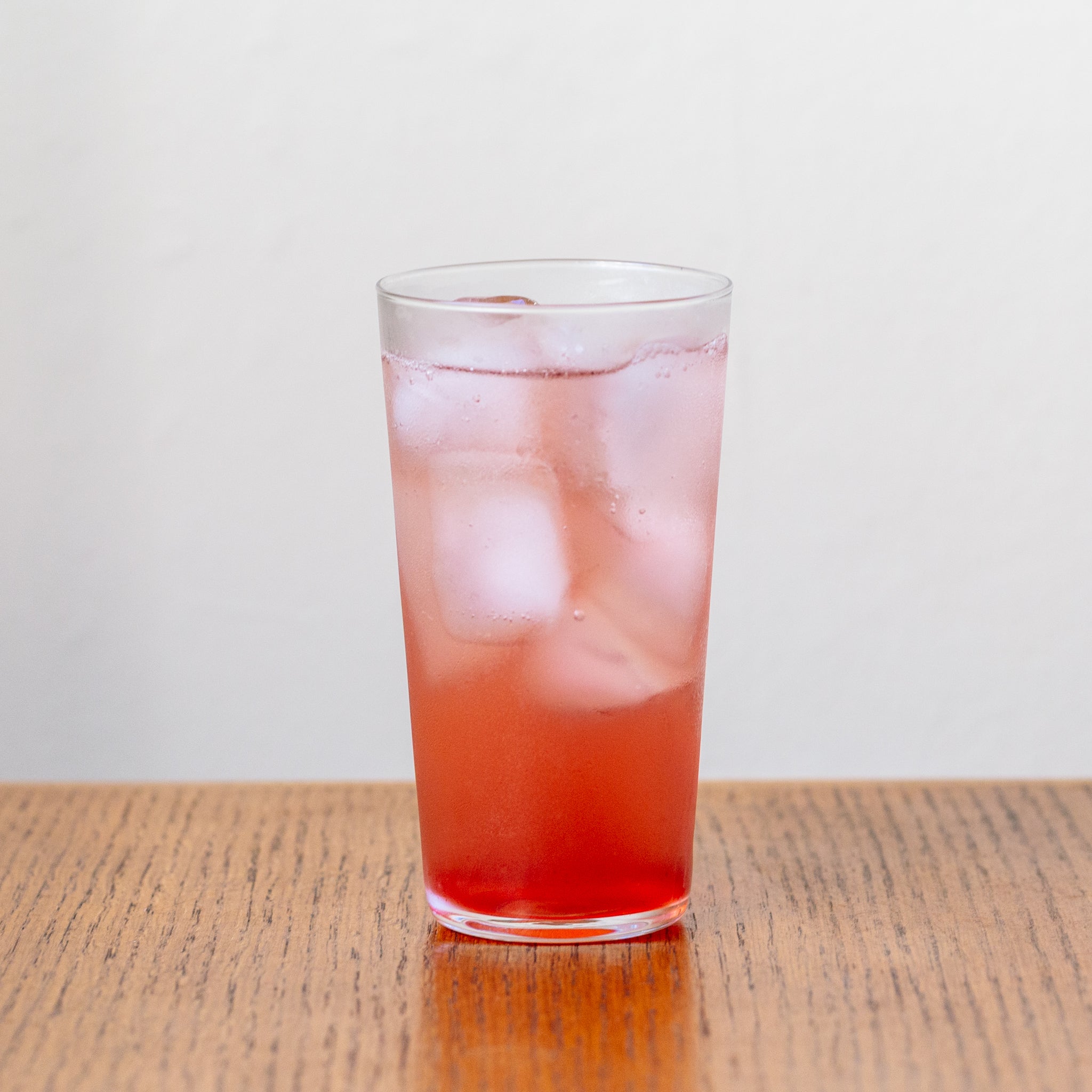 A glass of soda water with Honey Sweetened Purple Sweet Potato Vinegar Shrub