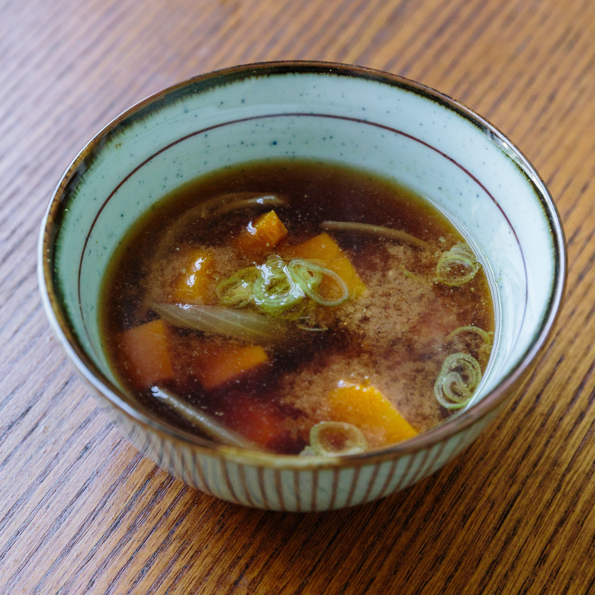 Japanese miso soup with kabocha pumpkin, onion, and sansho pepper