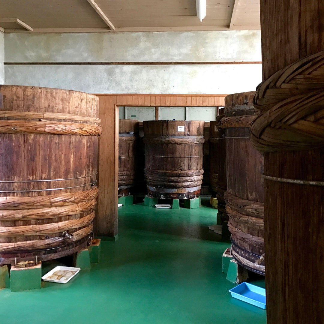 Traditional Japanese cedar aging barrels at a soy sauce brewery