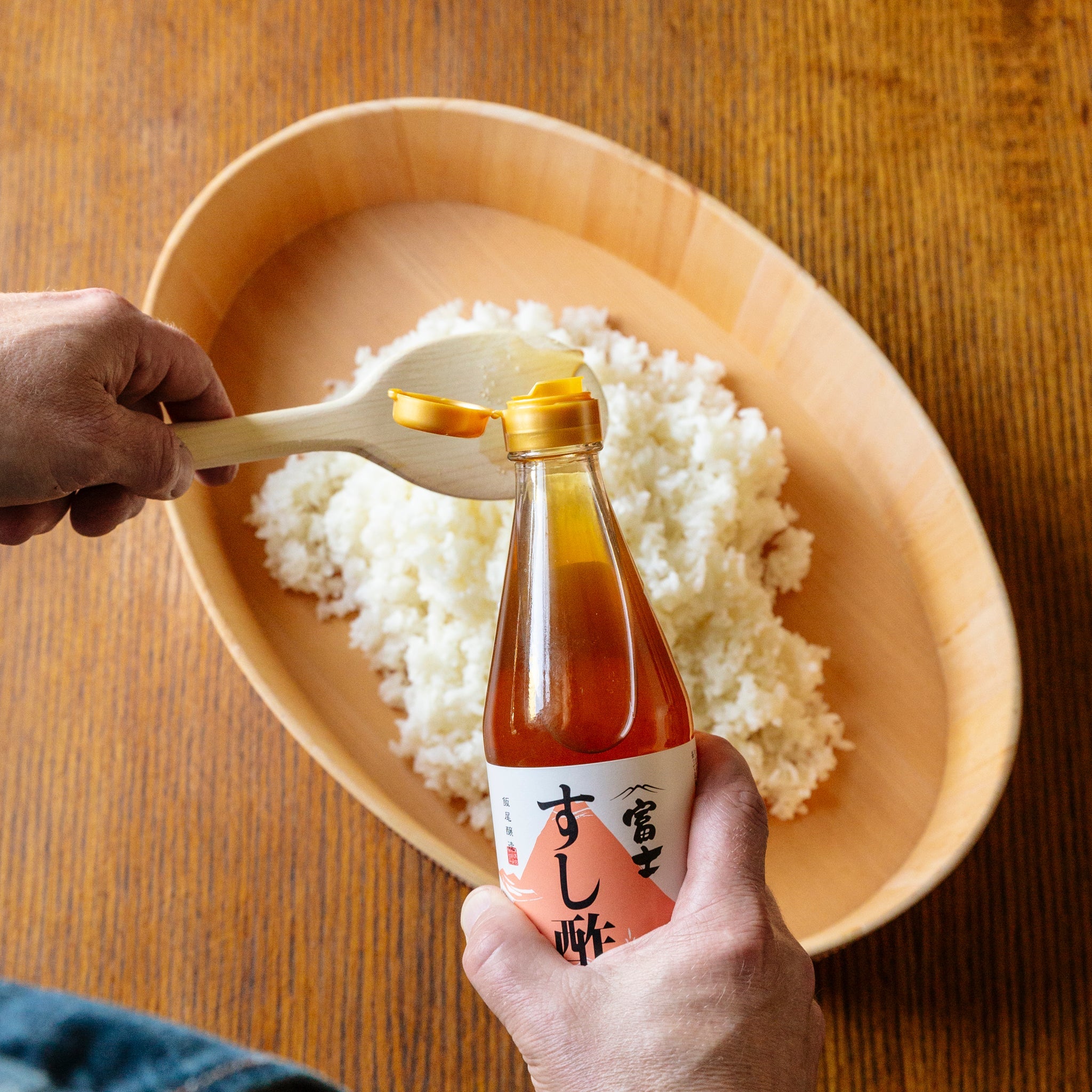 Sushi vinegar rice in a wooden oval container — seasoned with Iio Jozo pure rice vinegar
