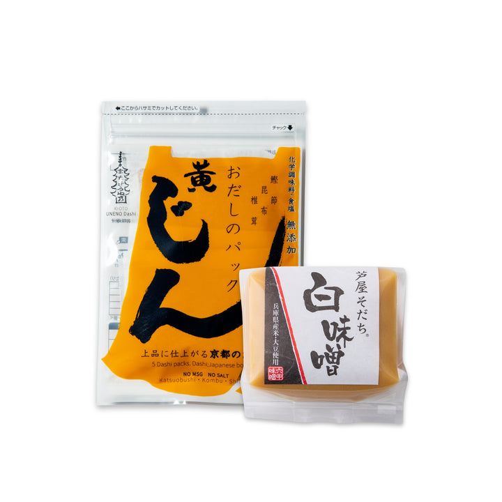 Two packaged Japanese snacks on a plain white background: a larger clear stand-up pouch with a large yellow label and black calligraphy, and a smaller clear packet with a white label and black calligraphy, both containing tan-colored snack pieces.