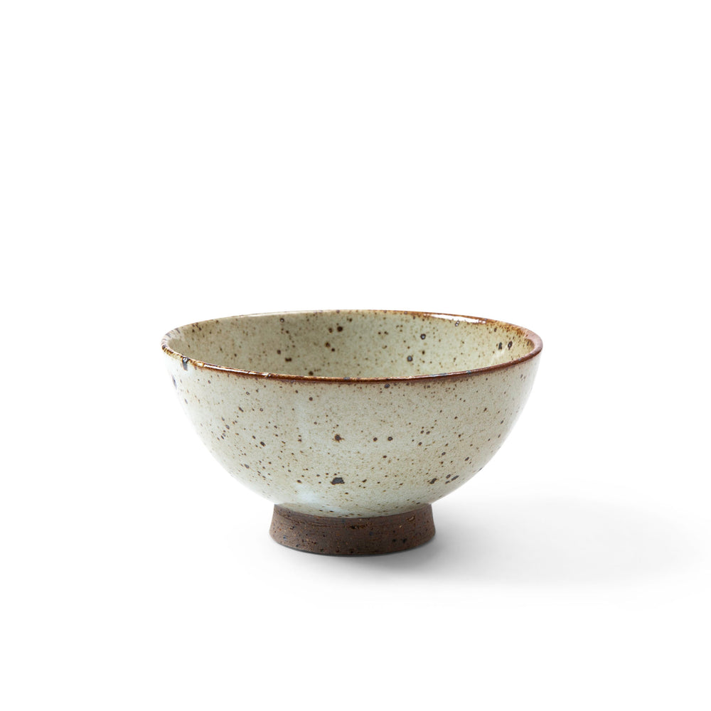 Small ceramic bowl with speckled texture on a white background