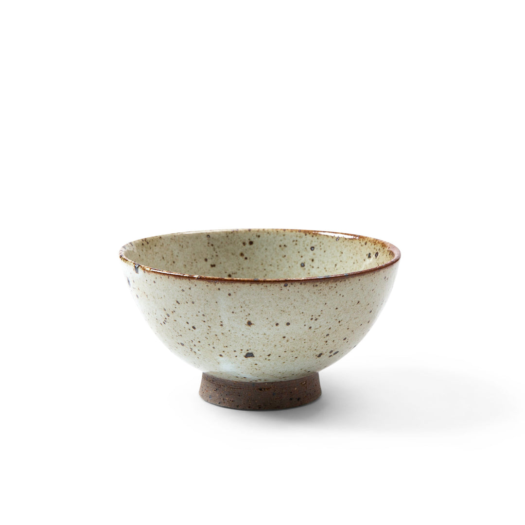 Small ceramic bowl with speckled texture on a white background
