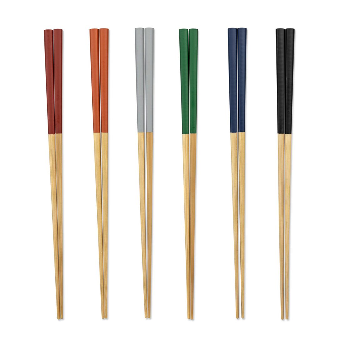 Set of six pairs of chopsticks with colored handles on a white background
