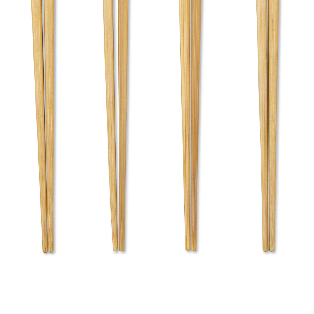 Closeup of tips of four pairs of chopsticks with colored handles on a white background