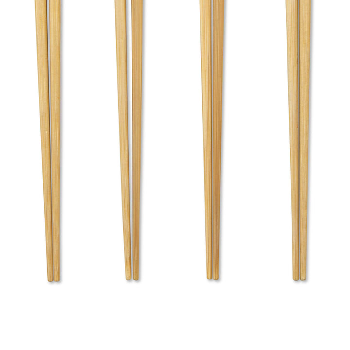 Closeup of tips of four pairs of chopsticks with colored handles on a white background