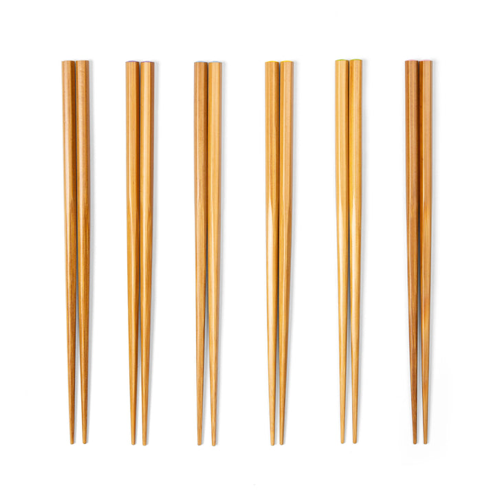 Set of six bamboo chopsticks on a white background