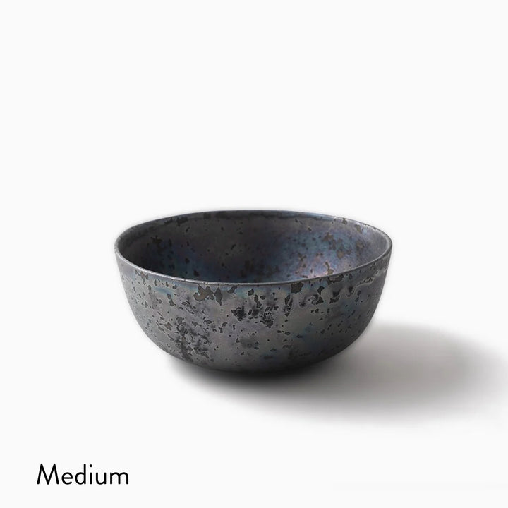 A medium-sized ceramic bowl with a textured, speckled dark gray and blue glaze, shown on a clean white background with a soft shadow and the word 'Medium' printed in the bottom-left corner.