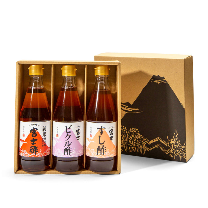 A boxed set of three Japanese soy sauce bottles displayed in front of their branded packaging box. The set includes rice, pickling, sushi vinegar, inside a kraft cardboard tray box.