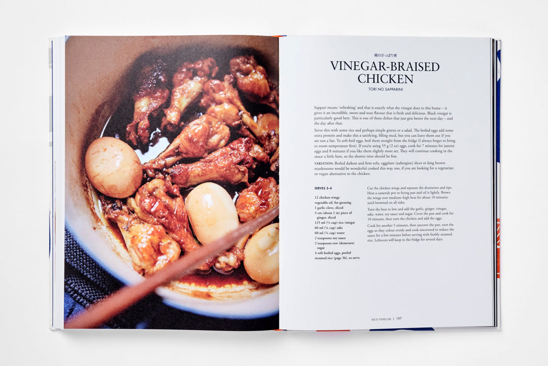 Open cookbook showing vinegar-braised chicken dish and recipe.