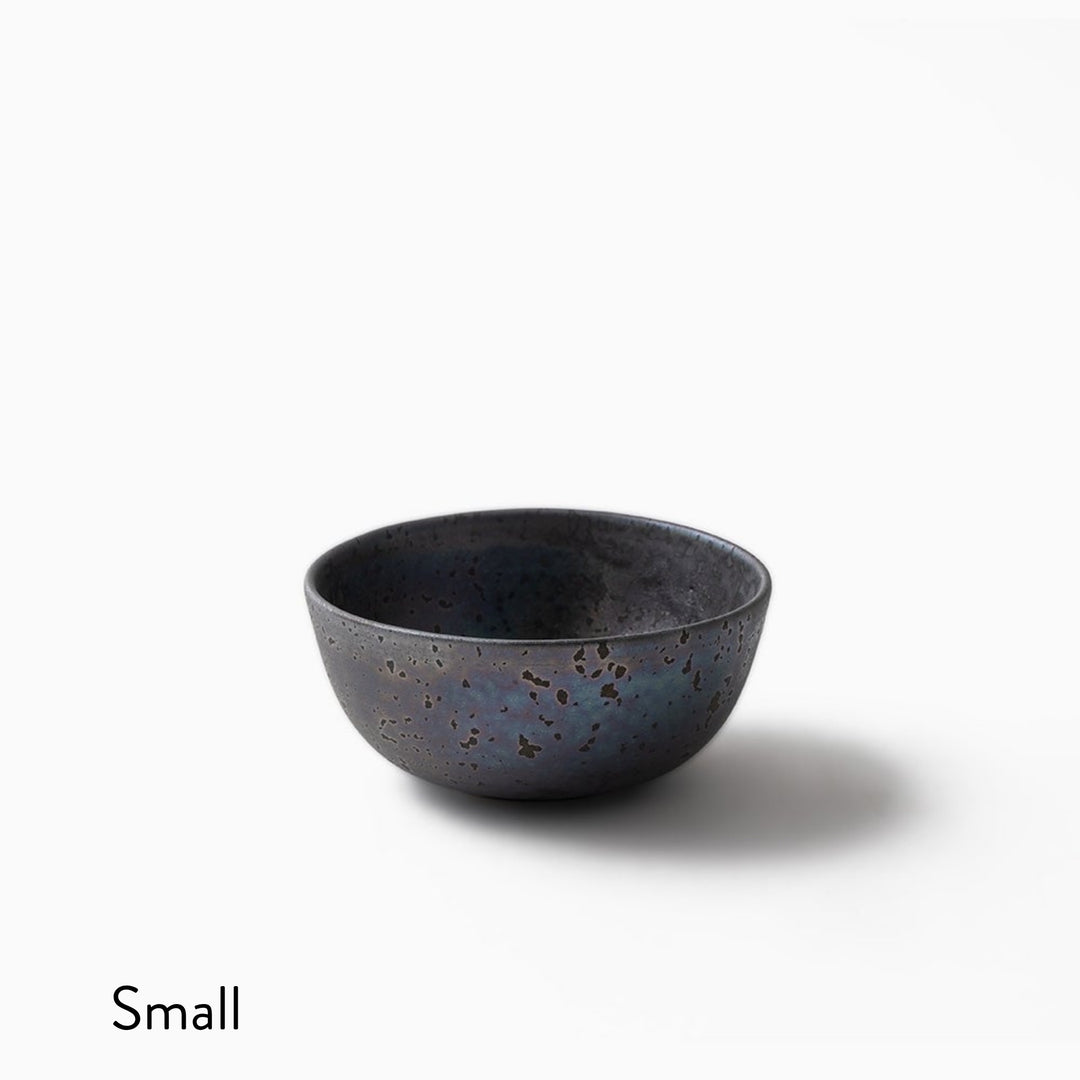 A small ceramic bowl with a speckled dark blue and black glaze, shown on a clean white background with the word 'Small' in the bottom-left corner.