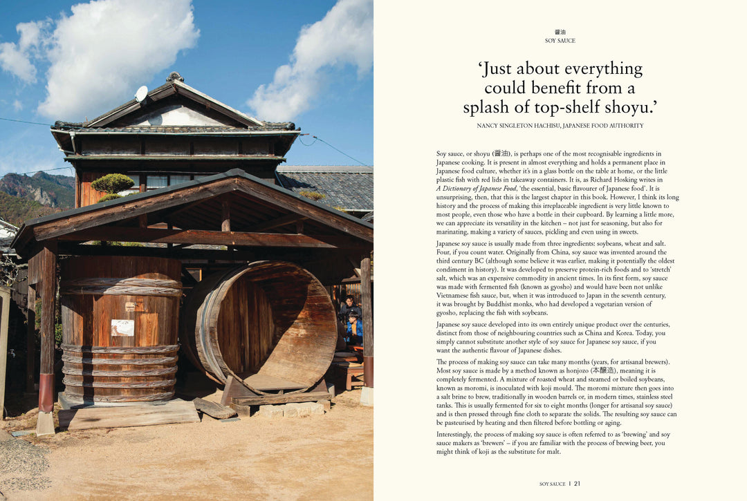 Traditional wooden building with large wooden barrels and scenic background