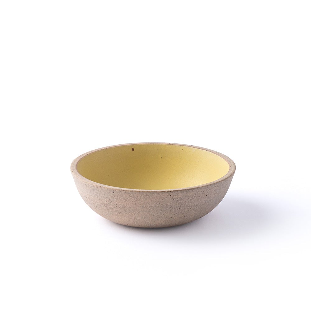 Ceramic bowl with a yellow interior on a white background