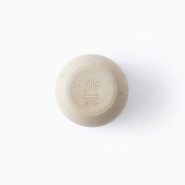 Gold jewelry connector with a round yellow gemstone on a white background