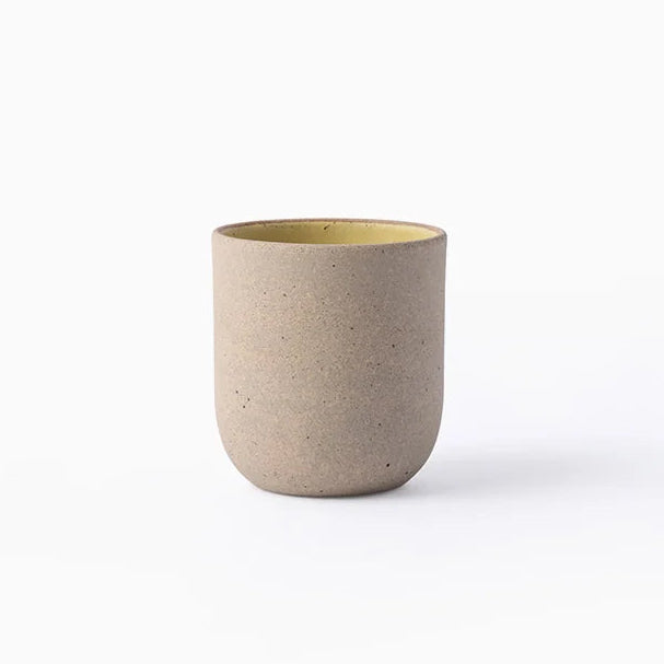 Beige ceramic cup on a white background