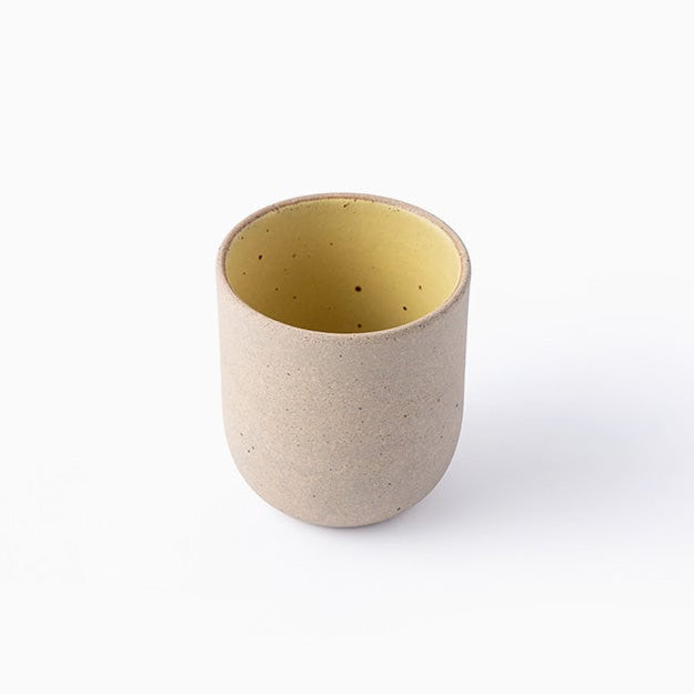 Ceramic cup with a beige interior on a white background