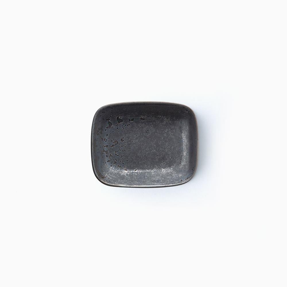 Small black ceramic bowl on a white background