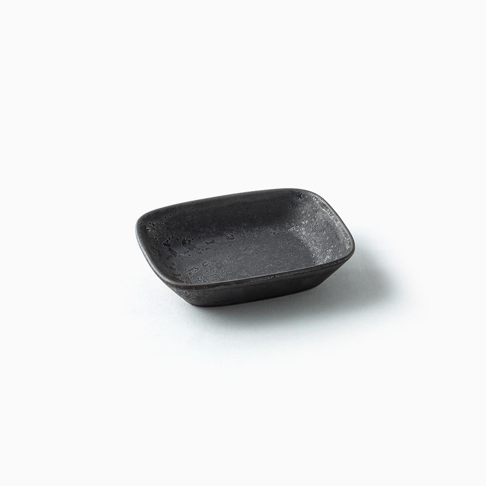Small black ceramic bowl on a white background
