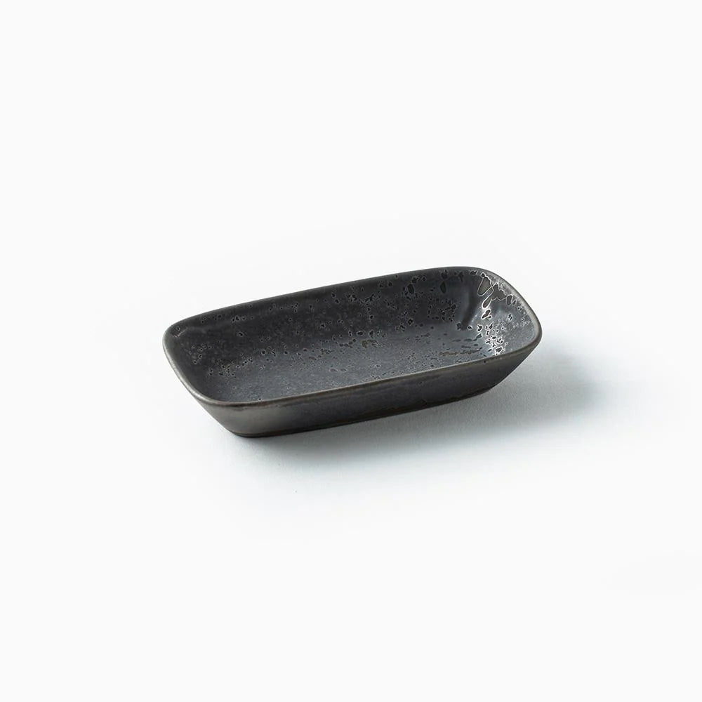 A small rectangular ceramic dish with rounded corners, featuring a dark charcoal gray speckled glaze, set against a plain white background.