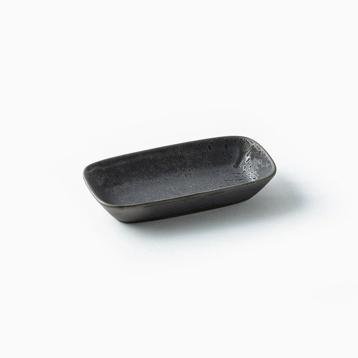 A small rectangular ceramic dish with rounded corners, featuring a dark charcoal gray speckled glaze, set against a plain white background.