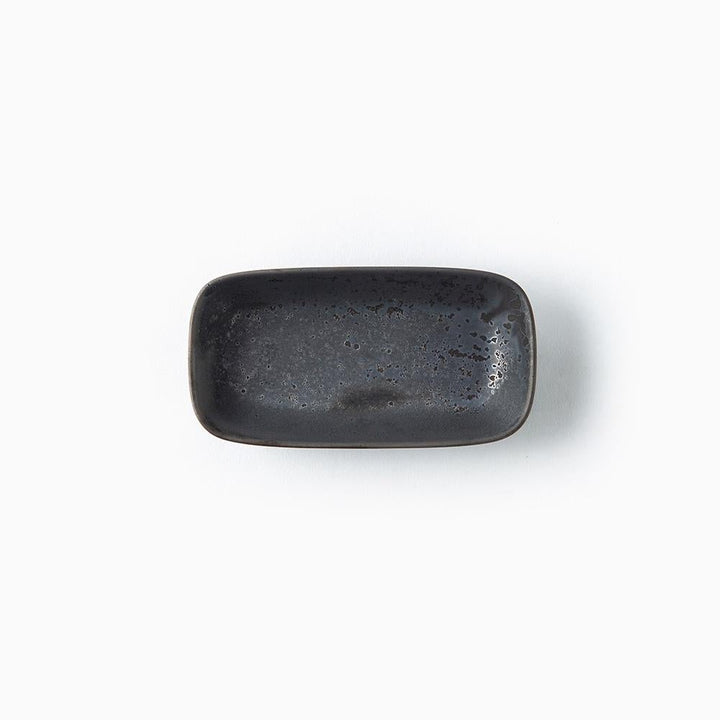 A small rectangular ceramic dish with rounded corners, featuring a dark charcoal gray to black speckled glaze, shown from a top-down view on a white background.